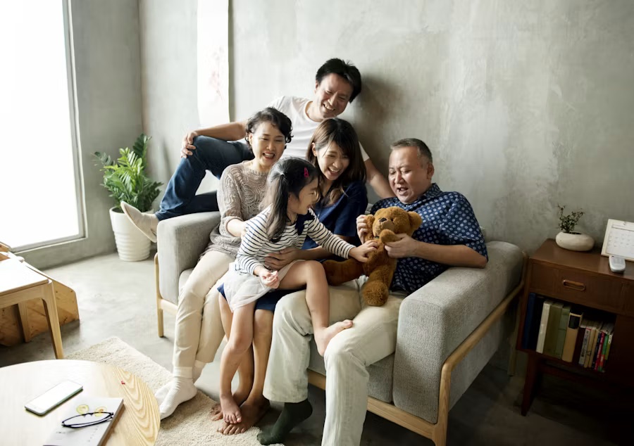 Happy family laughing and playing together happily, representing family love